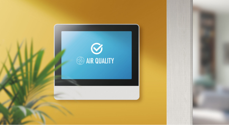 An image of a smart tablet displaying quality air control on an interior wall